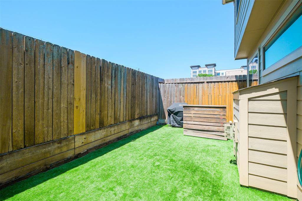 The pleasant rear yard has astro turf flooring.