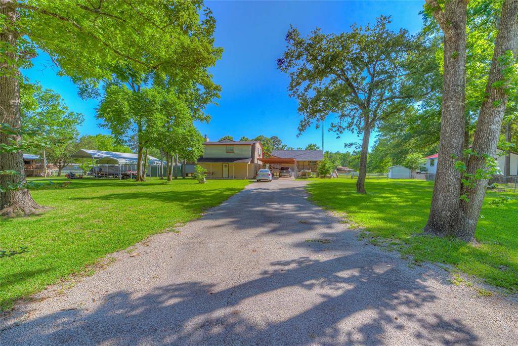 Ton of parking space with carport as well as paved driveway