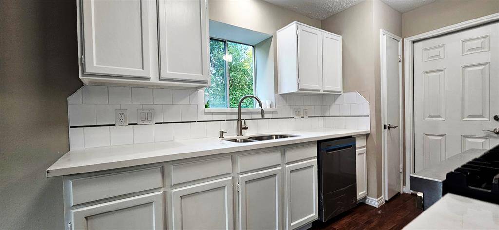 Kitchen is slightly open to Den with Quartz Counters, New D/W, and Microwave. Deep SS Sink and Brush Nichol pull down Faucet.