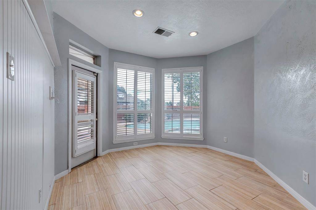 Breakfast room with beautiful bay windows overlooking the pool.
