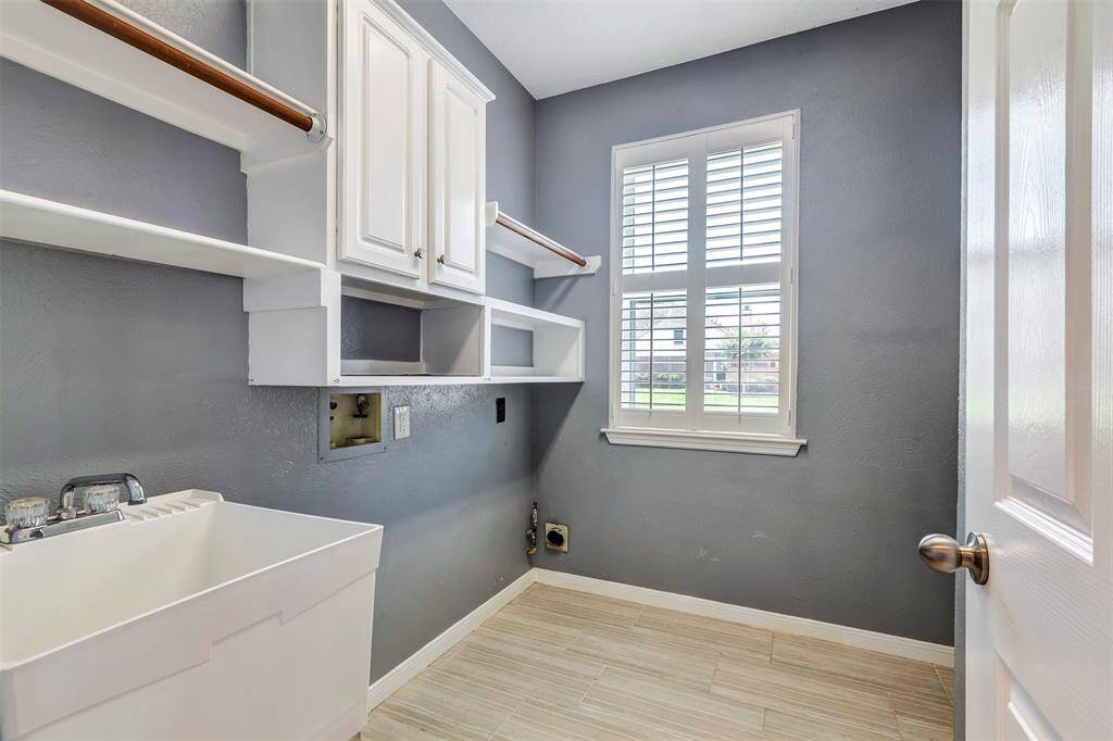 Even your utility room has ample storage with cabinet, shelves and hanging rod. It also offers a sink. Doing laundry will be a breeze in here!