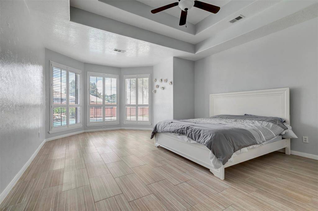 This primary bedroom is your private retreat! Bay windows overlooking the pool, recessed ceiling, space for a King size bed, drawer chest, bedside tables and a sitting area. What else can you ask for?