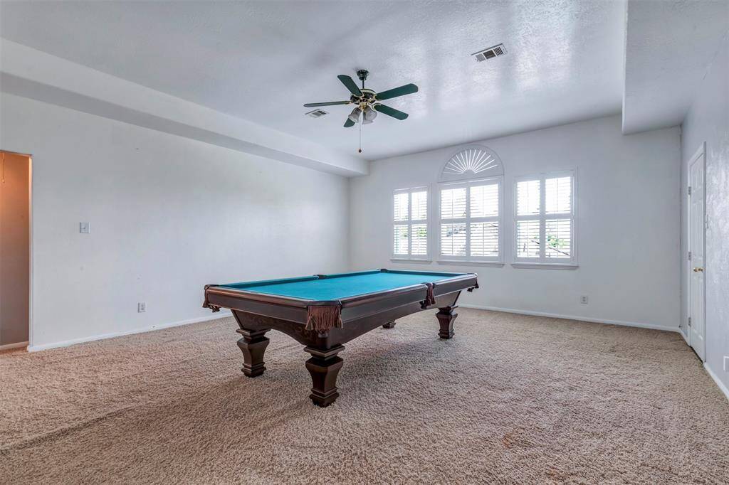 Turn this HUGE Game room in to the kid's area: couch for the teenagers, multiple play areas or multiple desks for the kids to do homework, family game room...the possibilities are endless! To the right is access to the large attic space for easy storage.