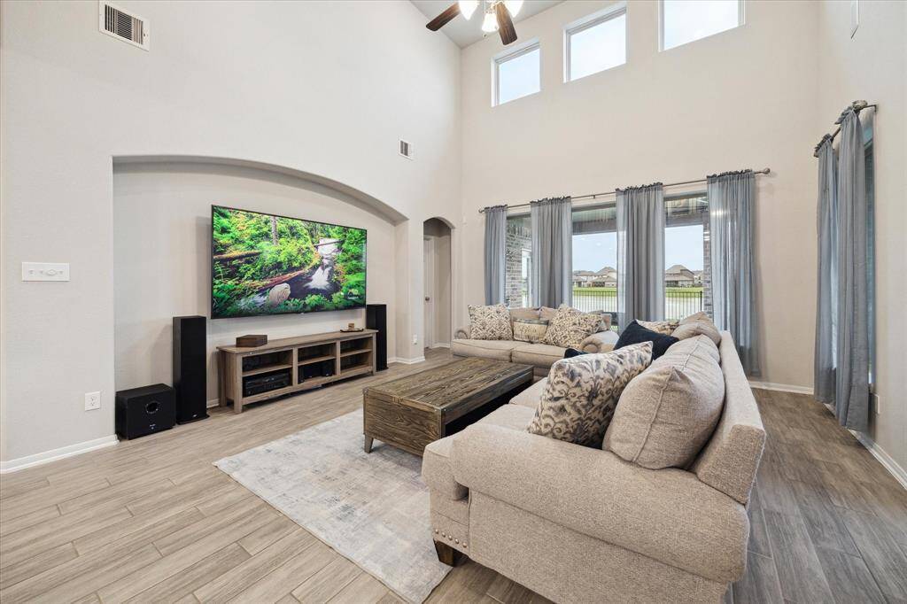 This photo does not capture everything, but you can see the open flow, where you see the natural flowers, that is the breakfast nook. There are some stairs as you get to this section as well and a hallway with the powder bath and laundry rooom.