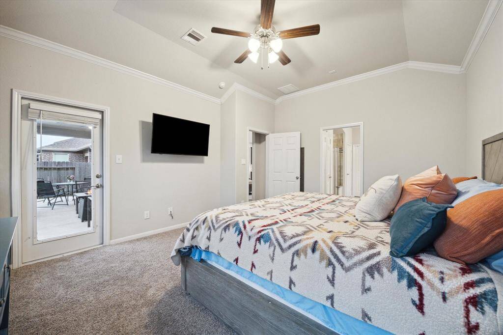 A view from the furthest vanity back to the bedroom showcasing the nice size shower and private lavatory.