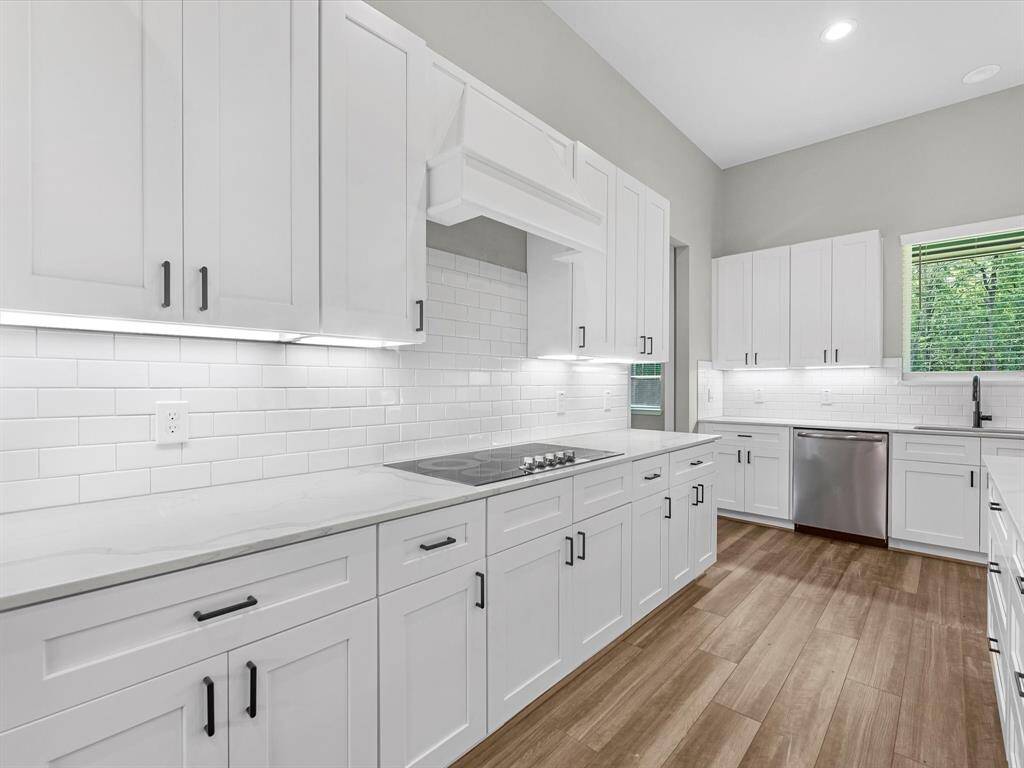 Custom vent-hood, electric cooktop, and plenty of working space and storage
