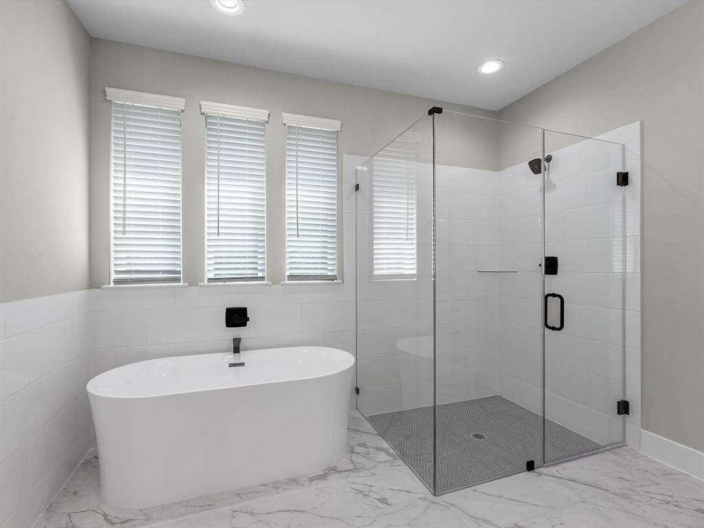 Frameless shower and a deep soaking tub