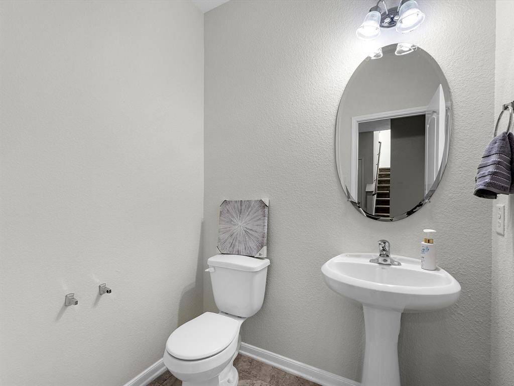 The downstairs half bath is tucked away for privacy and convenience!