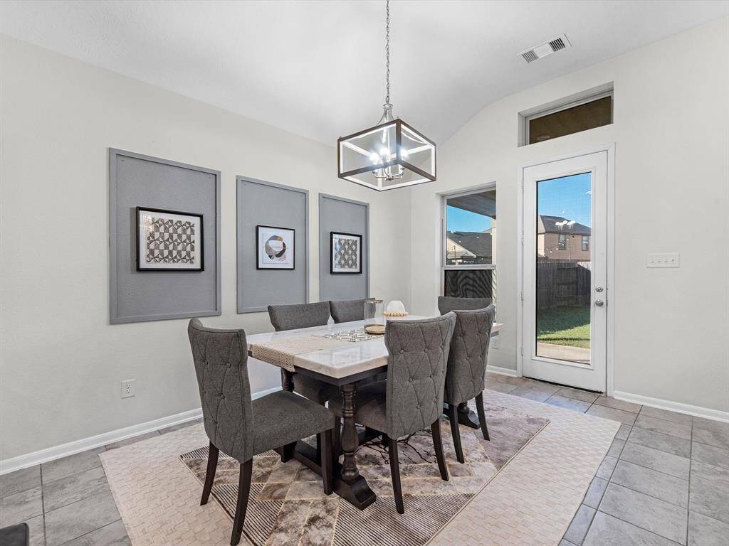Eat-in kitchen that accomodates a full size dining set with room for more.