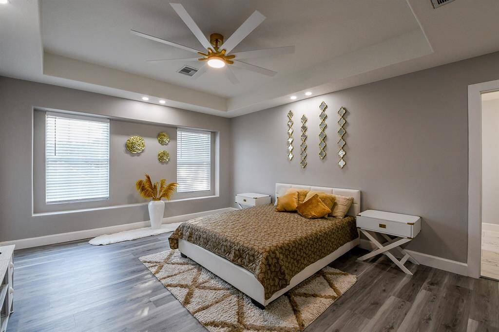 Primary bedroom with vaulted ceilings and a large modern ceiling fan!