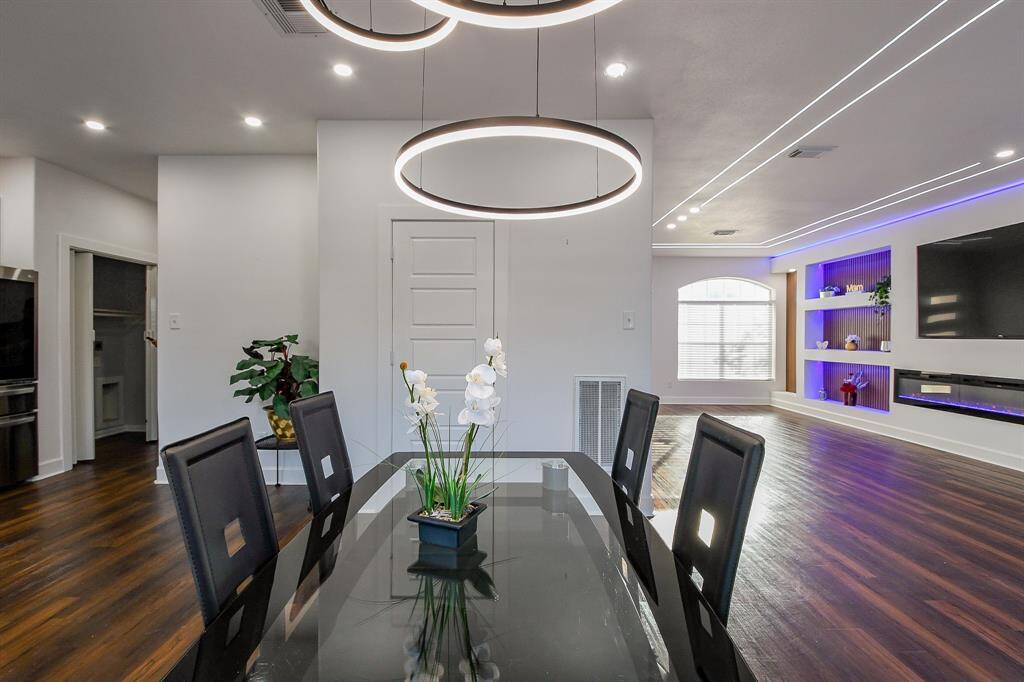 Dining area also adorned with recessed lighting and a modern chandelier!