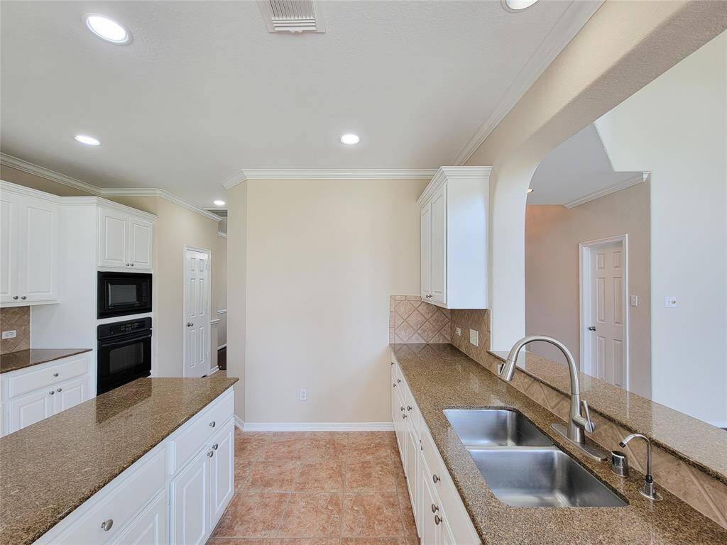 Island offers a generous prep-space. Freshly painted Kitchen cabinets, granite counters, crown molding & recess-lights are other features.