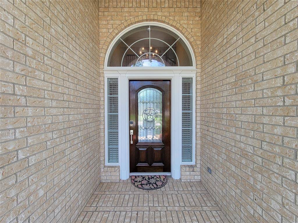 Inviting brick Porch-entry. Recently update full length leaded front door. Come on in...!!