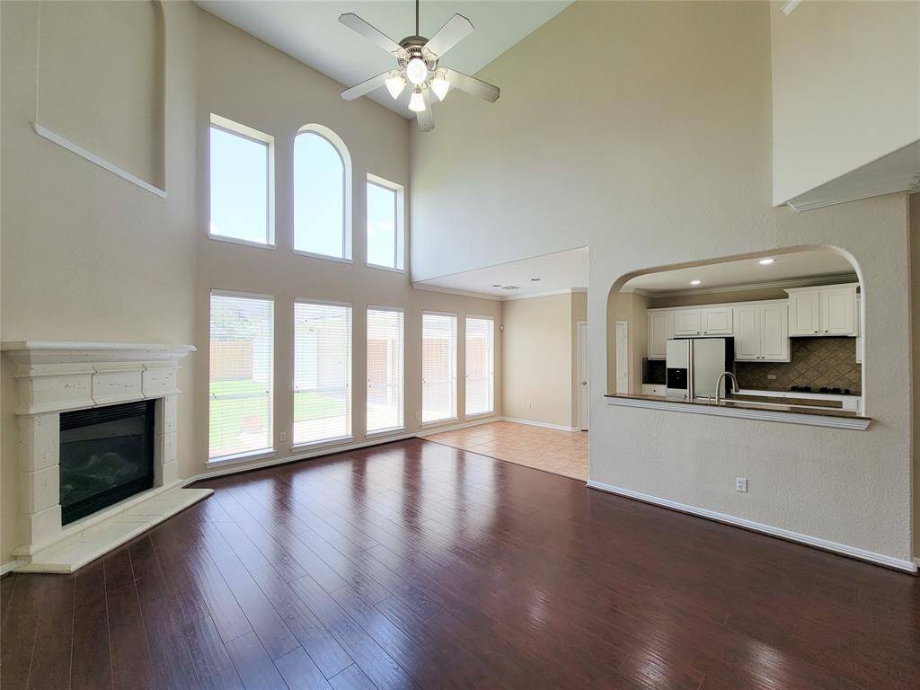Family room with soaring ceilings & rows of windows bringing in all the natural light.
