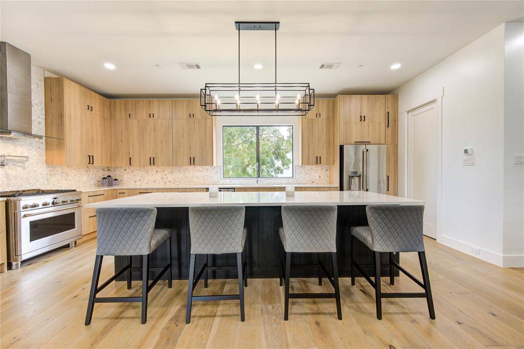 This oversized island is the focal point in this custom built kitchen. Lots of storage on both sides too!