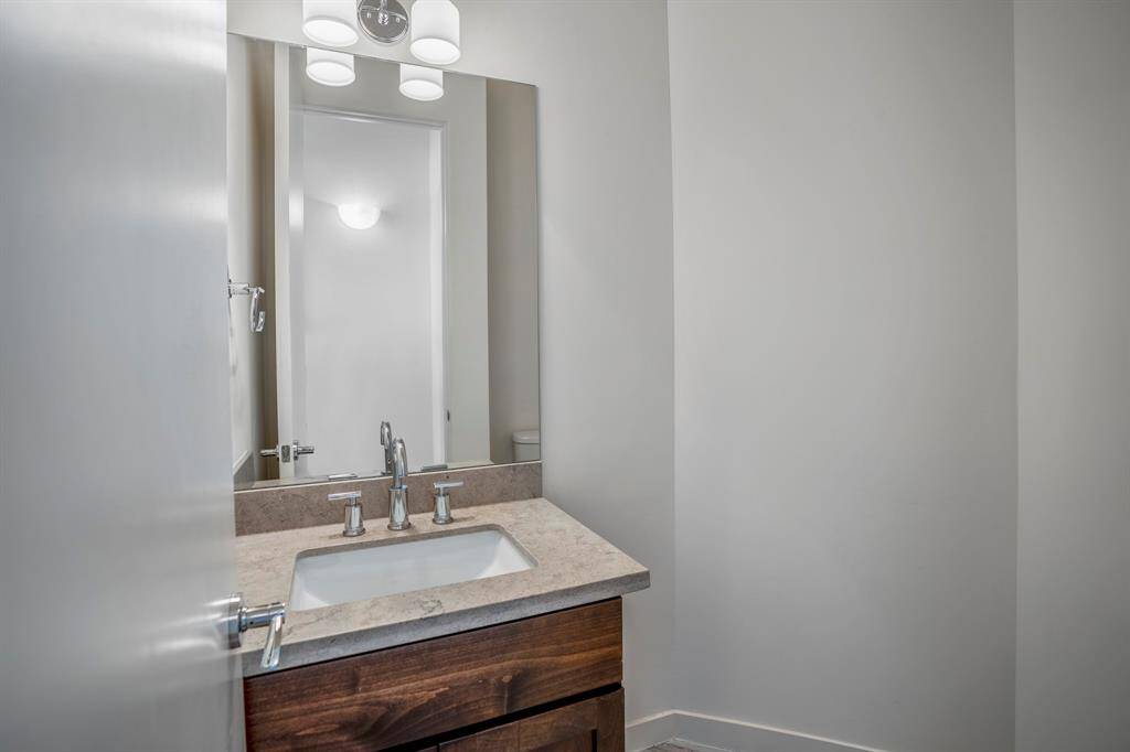 This is the powder bath located on the second level with hardwood floors, granite counters, and designer fixtures.