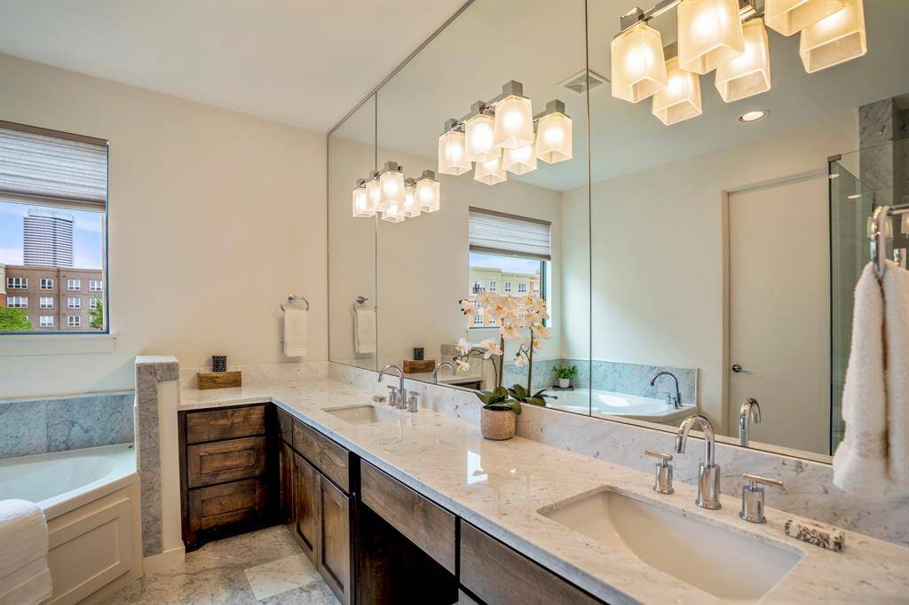 His and her vanity with plenty of counter space and storage & designer fixtures and lighting.