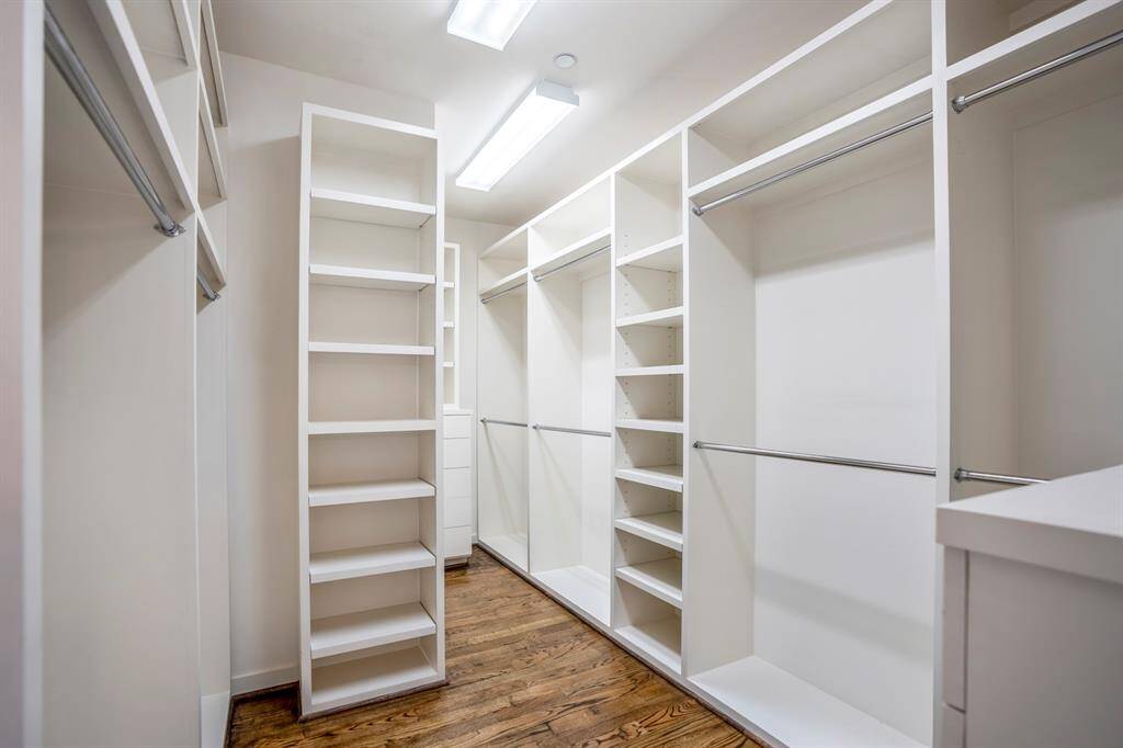 The spacious custom fitted primary closet.