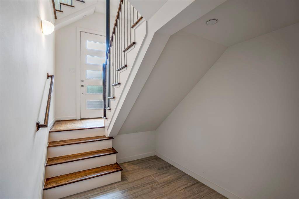 At the entrance, you are greeted with the modern contemporary front door that leads down to the first level and up to the other 3 floors. For added convenience, this home comes equipped with an elevator closet on each level, providing potential access to all 4 floors.