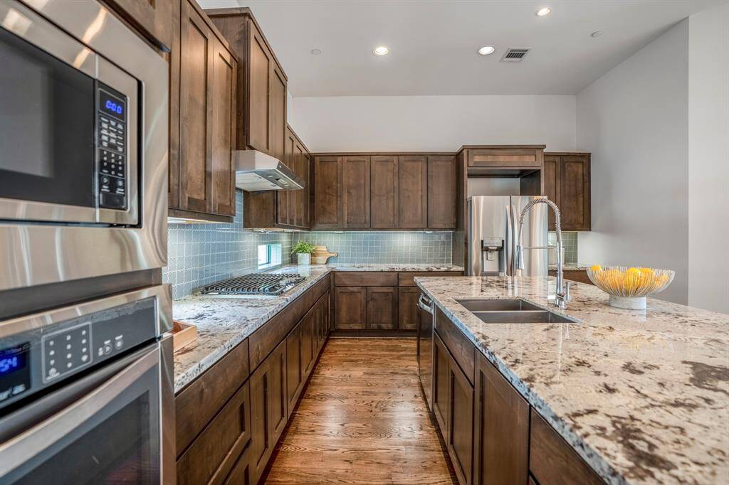 Wood cabinets, soft close hinges, recessed lighting and hardwood flooring throughout.