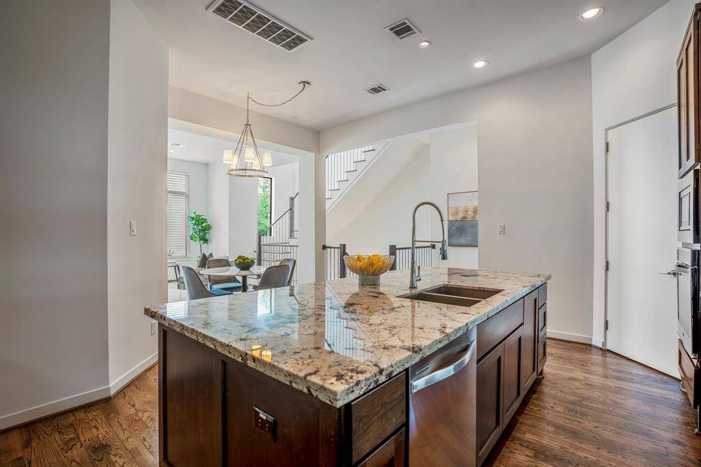Another view of the kitchen as it flows into the dining and family room. There is also a spacious walk-in pantry.