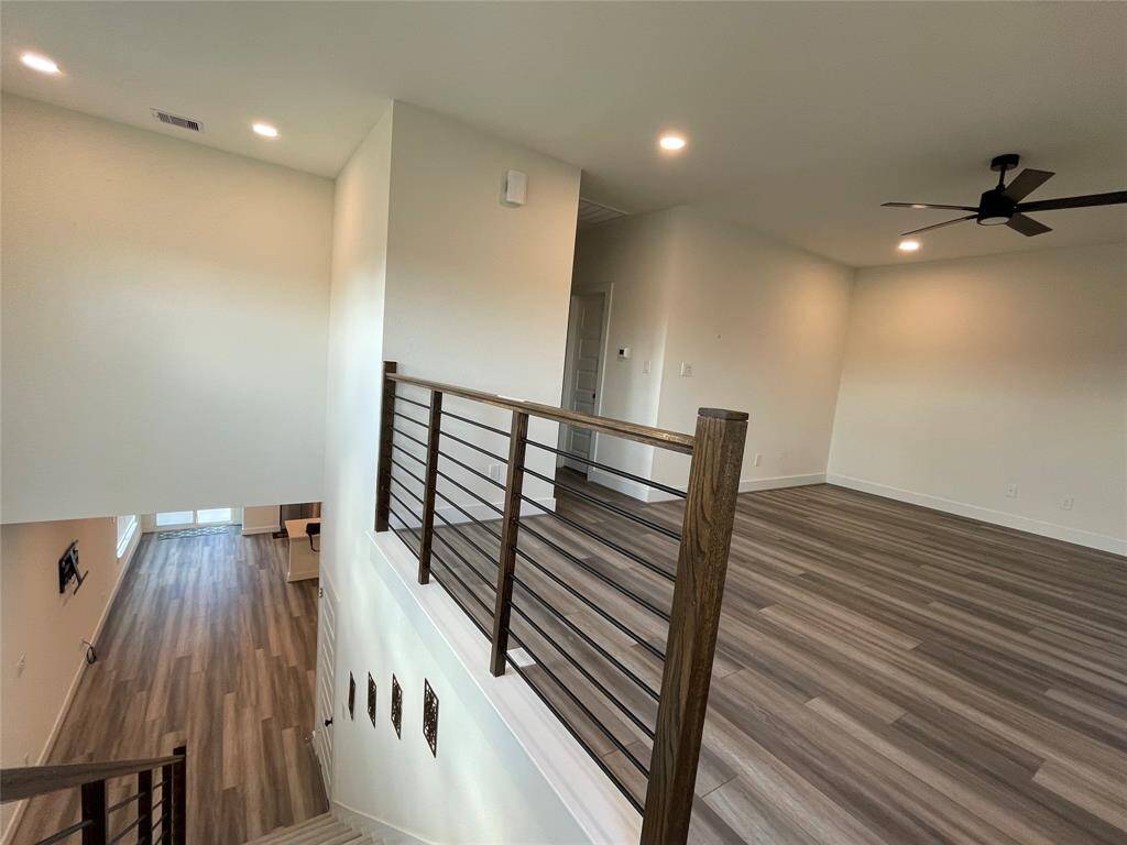 Staircase Leading to big Pool Table size Game Room or secondary living area with access to balcony with French Doors.