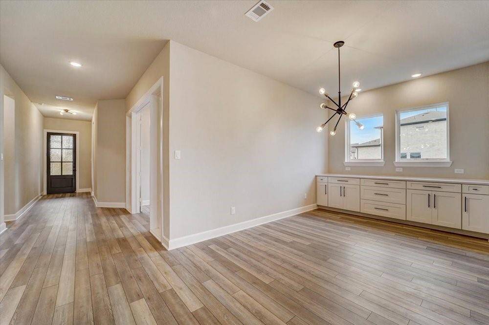 EXAMPLE PHOTO: Low maintenance vinyl plank floors, high ceilings, 8 ft solid core doors & spacious Dining with built in cabinets!