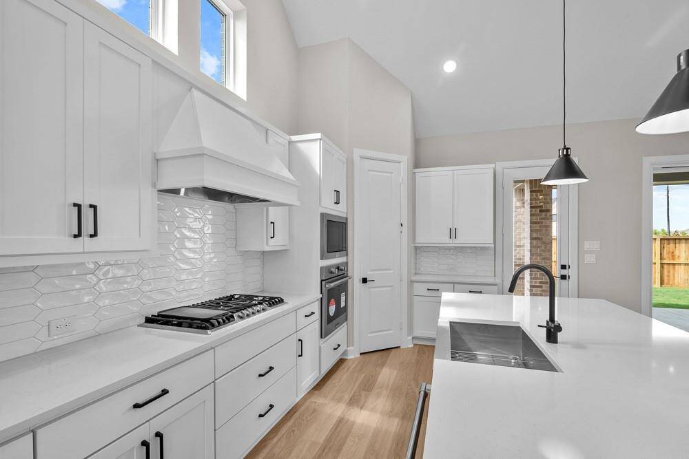 EXAMPLE PHOTO: 36 in gas cooktop with updraft vent hood, quartz counters, pot/pan self close drawers & more!