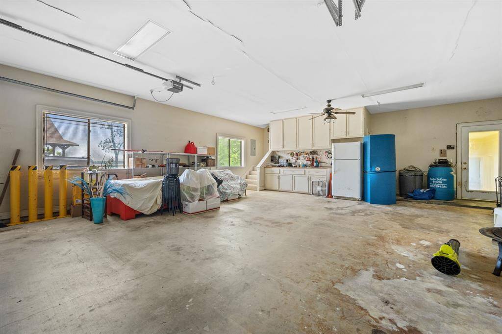 3 Car Garage has workbench area and storage.