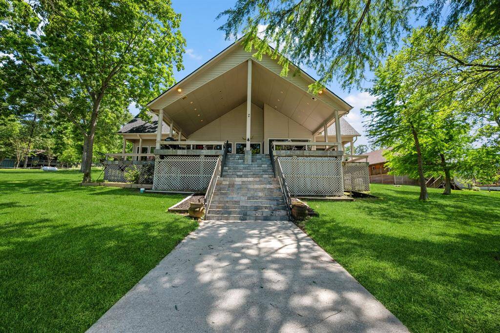 Lucious backyard space.  Cathedral tall covered back patio, tons of deck space and ~15x30 enclosed and concrete pad storage underneath to the right.
