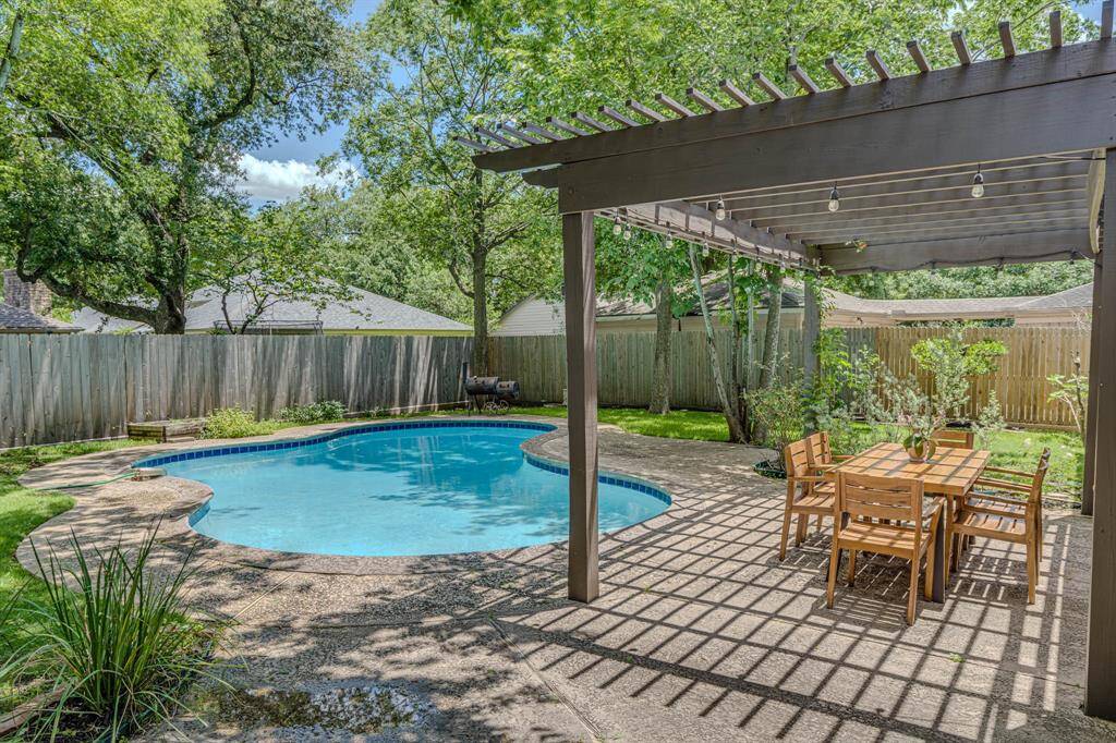 pergola anchors the poolside oasis—perfect for lounging, dining, or entertaining under the shade.