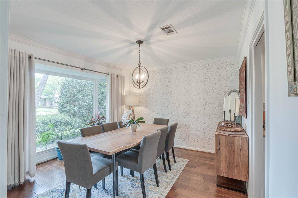 Bathed in natural light, this inviting dining room is anchored by a striking picture window