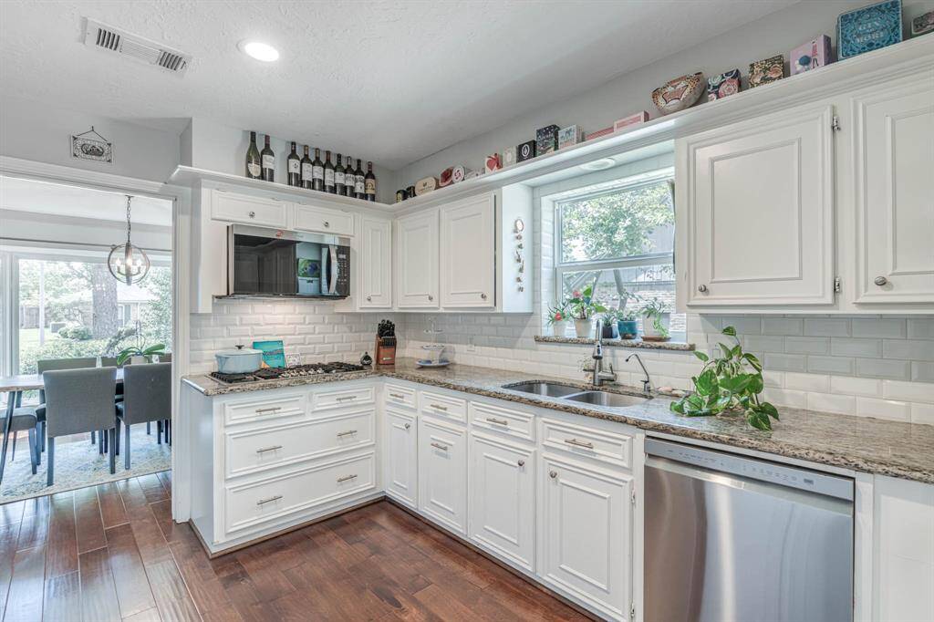The chef-inspired kitchen boasts gleaming granite countertops, crisp white cabinetry, and a sleek gas cooktop—perfect for both everyday meals and entertaining guestsThe chef-inspired kitchen boasts gleaming granite countertops, crisp white cabinetry, and a sleek gas cooktop—perfect for both everyday meals and entertaining guests."The chef-inspired kitchen boasts gleaming granite countertops, crisp white cabinetry, and a sleek gas cooktop—perfect for both everyday meals and entertaining guests."