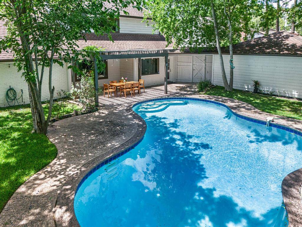 Step into your private backyard oasis featuring a sparkling resort-style pool, perfect for cooling off on warm Texas days.