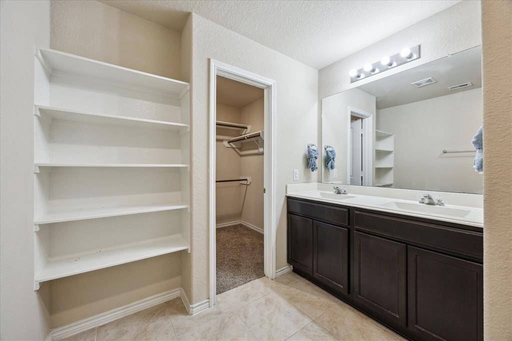 Master bathroom with double vanity, built in shelf