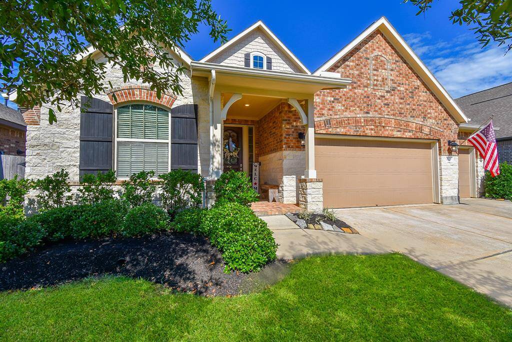 This charming home shows pride of ownership. The stone and brick elevation create a welcoming facade. Sprinkler system and lush landscaping.
