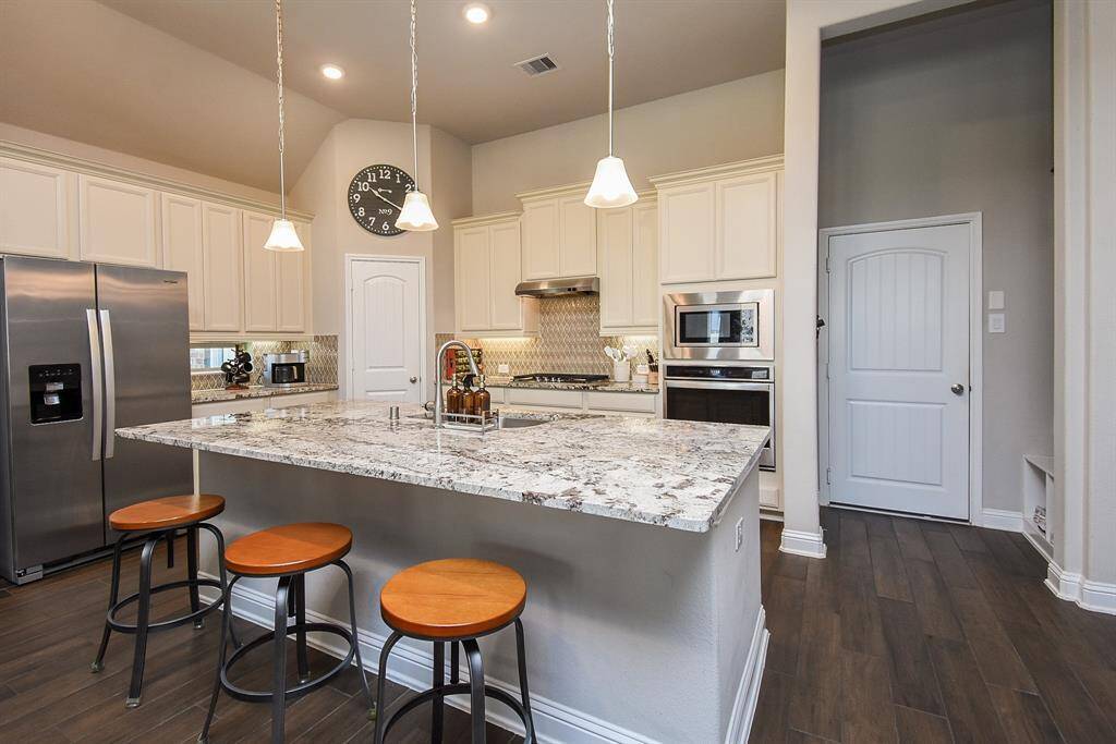 Beautiful granite enhances the island. There are counter windows allowing more natural lighting into the kitchen. Both pendant and recessed lights.