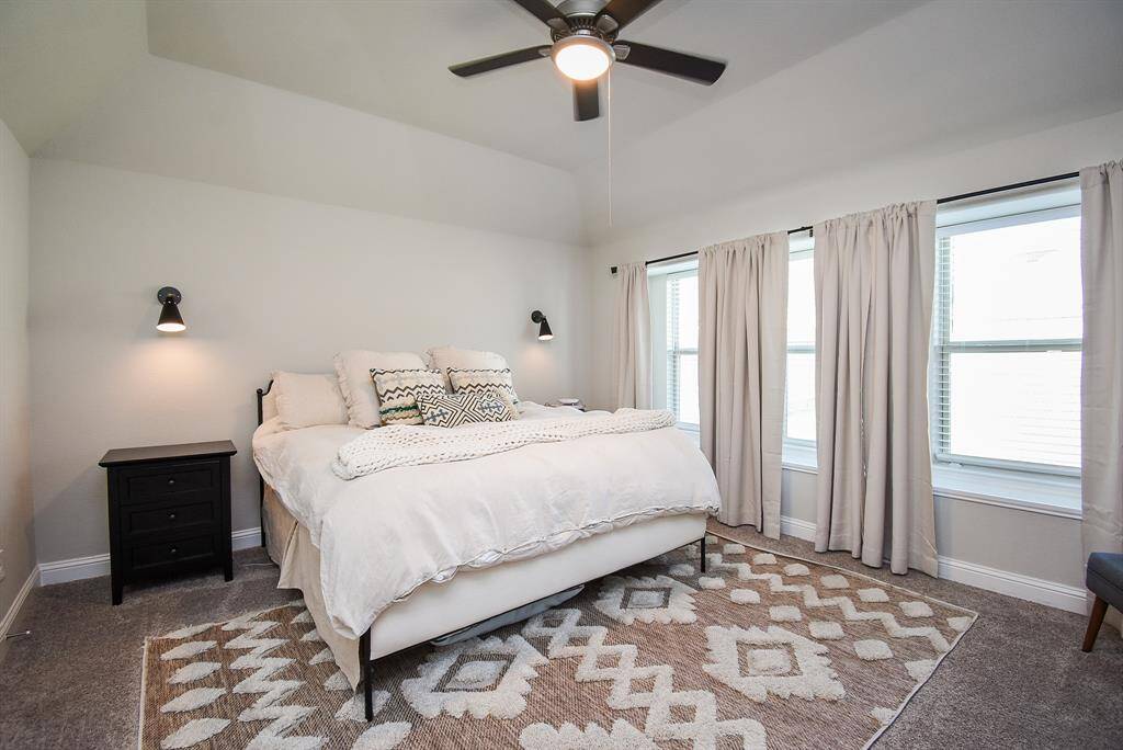 The primary bedroom has windows with views to the yard. Plenty of space for a king sized bed.