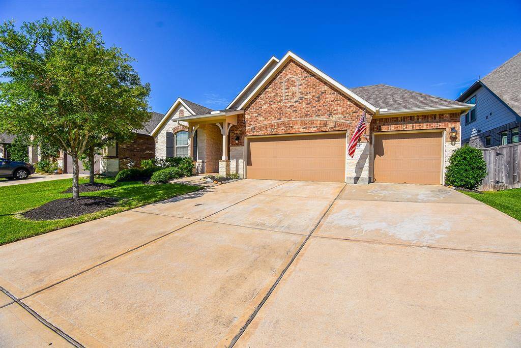 Wide driveway and Three car garage are a plus.