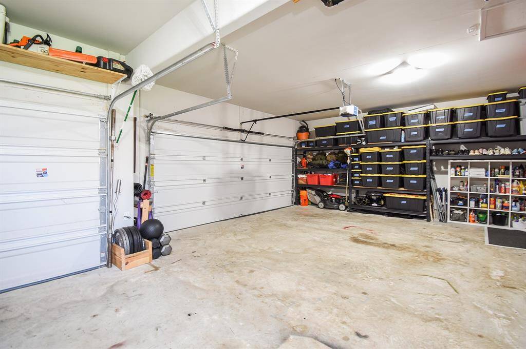 Three car garage has great space and a door to the backyard space not shown.