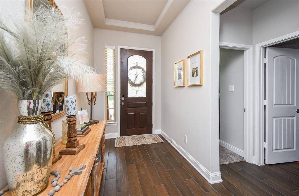 Foyer with wood look tile is a warm color. Neutral tones throughout the home.