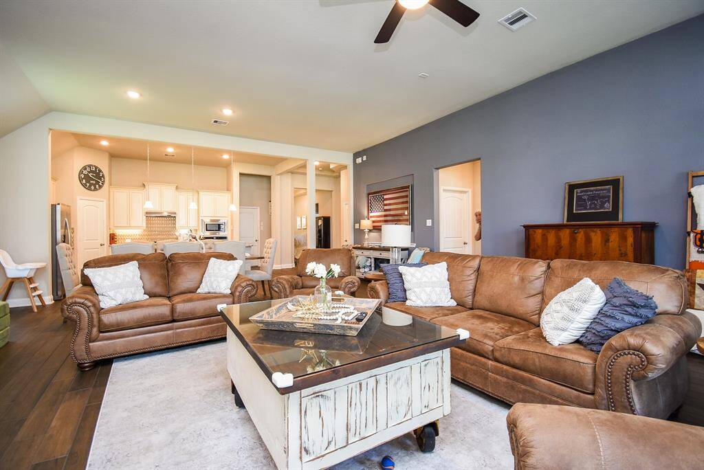 The spacious family room has a cast stone fireplace and custom shelves. The gas log fireplace will bring hours of pleasure during the chilly months.