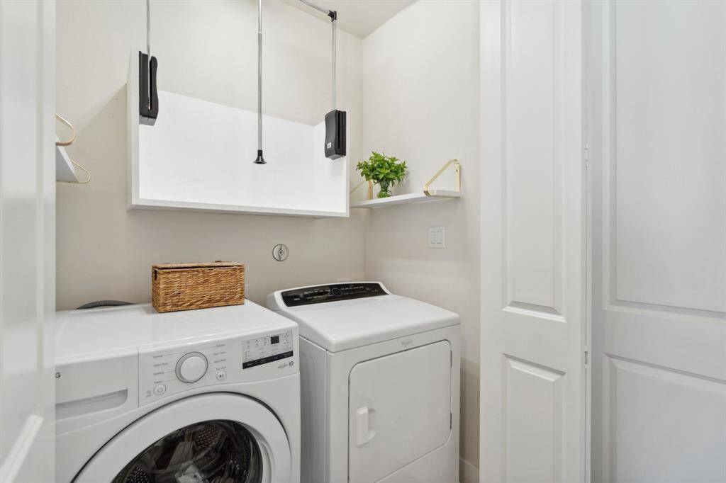 The laundry with shelves and pull down hanging space and shelves.