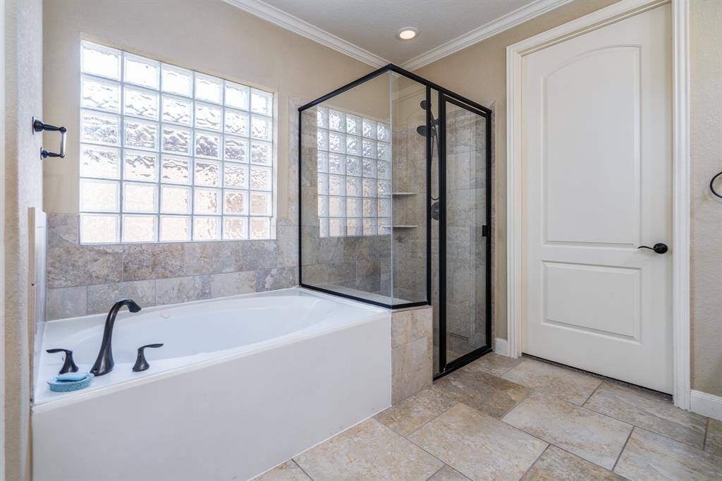 Primary bath with separate tub and shower.