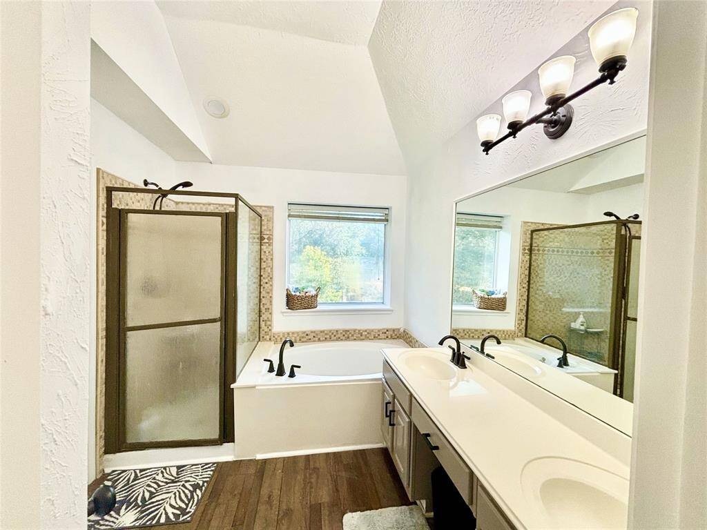 Primary bathroom with double sinks, separate garden tub and shower