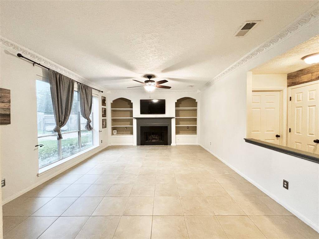 Gas fireplace punctuates this roomy living area