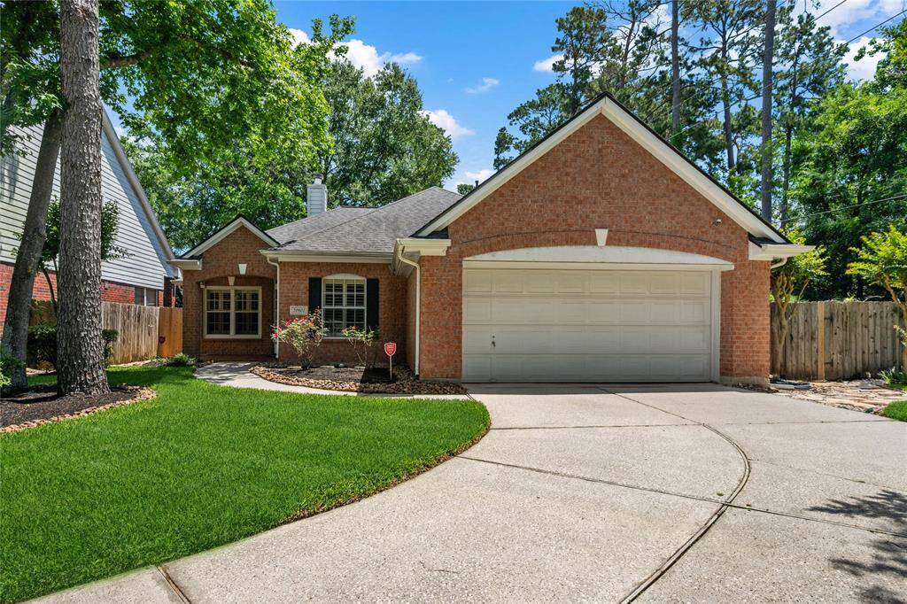 Charming single-story brick home with a two-car garage. The property features a well-maintained front yard with mature trees and a curved driveway. The inviting entrance is complemented by a neatly landscaped garden. Perfect for buyers seeking a cozy, suburban feel.