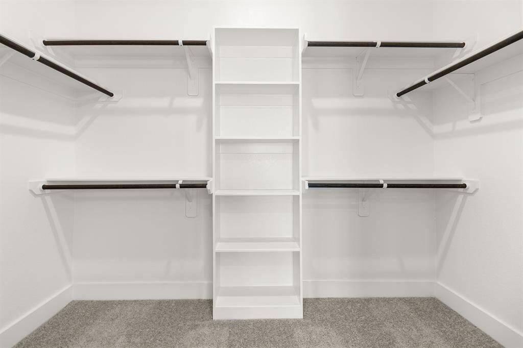 This closet is a perfect blank canvas to design a custom closet with ample hanging space, perfectly organized drawers, and chic shoe racks come together seamlessly, ensuring that everything has its place.