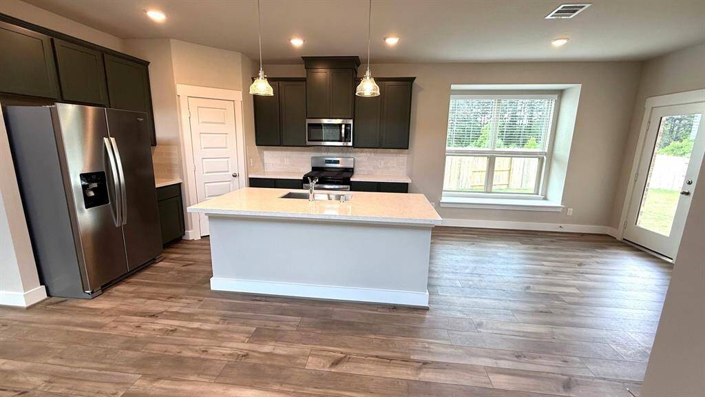 Natural light pours in through large windows, creating a bright and airy atmosphere that makes cooking feel less like a chore and more like a delightful experience.