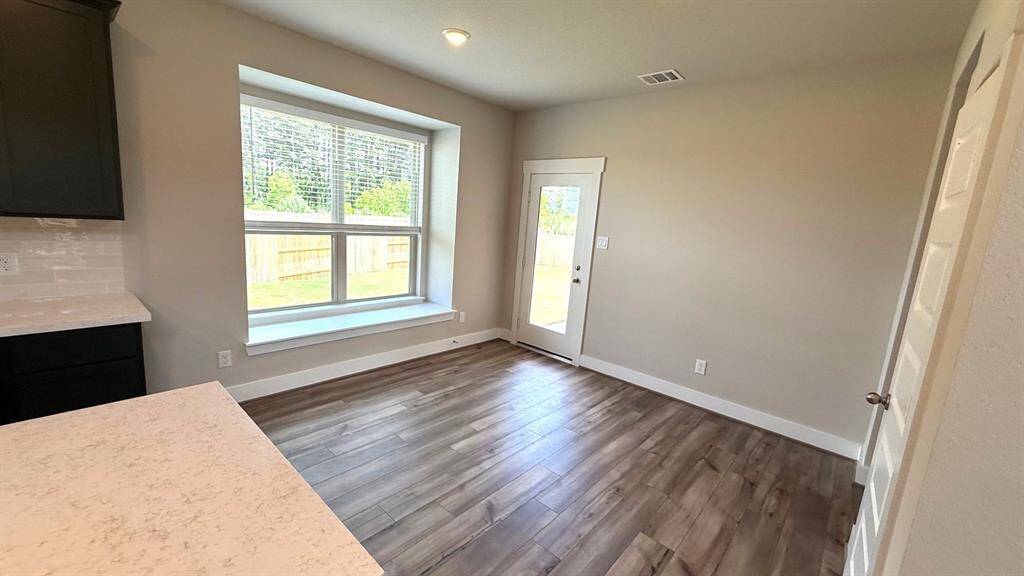 You'll love how the open layout seamlessly connects to the kitchen, making it easy to serve up your favorite dishes while still being part of the conversation.